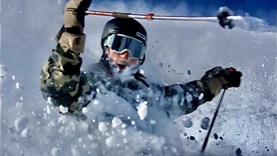 A skier buried in a powder face shot, snow flying past the goggles